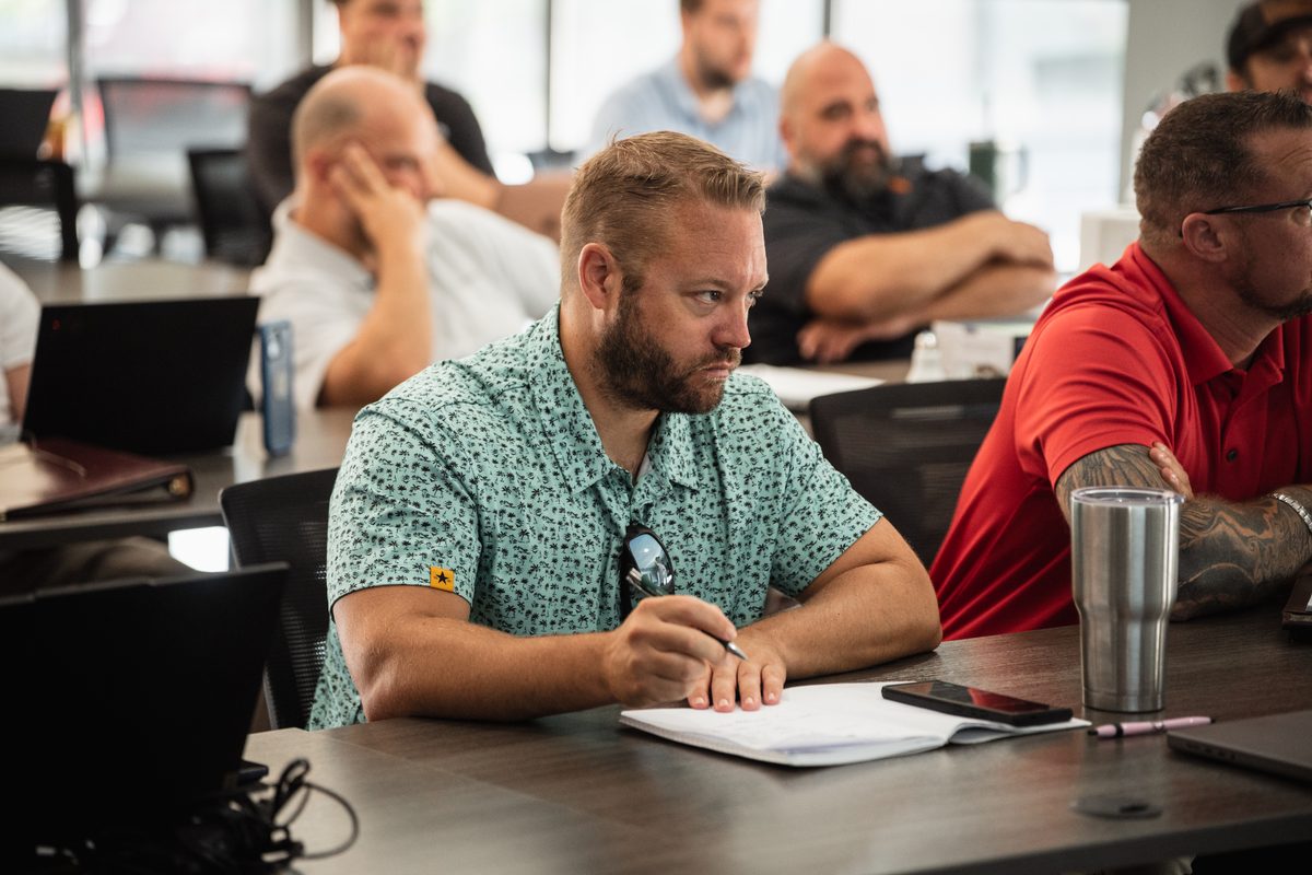 A member taking notes while a position is presented